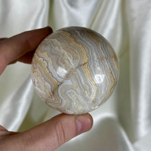Load image into Gallery viewer, 10.7oz Banded Calcite & Agate “Creamsicle” Sphere (imperfect)