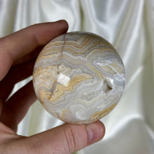 Load image into Gallery viewer, 10oz Banded Calcite & Agate “Creamsicle” Sphere (imperfect)