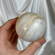 Load image into Gallery viewer, “Creamsicle” Banded Calcite Sphere