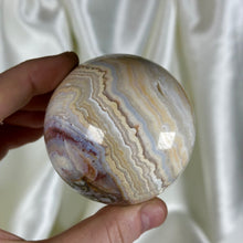 Load image into Gallery viewer, 10.4oz Banded Calcite & Agate “Creamsicle” Sphere with Pyrite (imperfect)