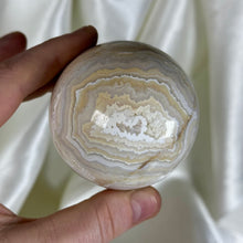 Load image into Gallery viewer, 10.7oz Banded Calcite & Agate “Creamsicle” Sphere (imperfect)