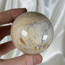 Load image into Gallery viewer, 10oz Banded Calcite & Agate “Creamsicle” Sphere (imperfect)