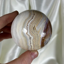 Load image into Gallery viewer, 10.4oz Banded Calcite & Agate “Creamsicle” Sphere with Pyrite (imperfect)