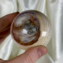 Load image into Gallery viewer, 10.4oz Banded Calcite & Agate “Creamsicle” Sphere with Pyrite (imperfect)