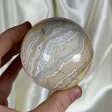 Load image into Gallery viewer, 12.8oz Banded Calcite & Agate “Creamsicle” Sphere (imperfect)
