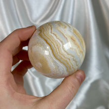 Load image into Gallery viewer, “Creamsicle” Banded Calcite Sphere