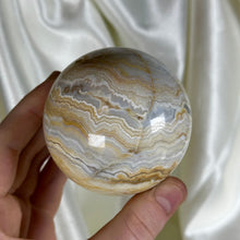 Load image into Gallery viewer, 13.9oz Banded Calcite & Agate “Creamsicle” Sphere (imperfect)