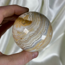 Load image into Gallery viewer, 10.4oz Banded Calcite & Agate “Creamsicle” Sphere