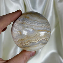Load image into Gallery viewer, 12.8oz Banded Calcite & Agate “Creamsicle” Sphere (imperfect)