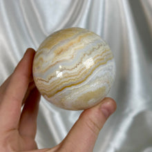 Load image into Gallery viewer, “Creamsicle” Banded Calcite Sphere
