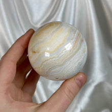 Load image into Gallery viewer, “Creamsicle” Banded Calcite Sphere
